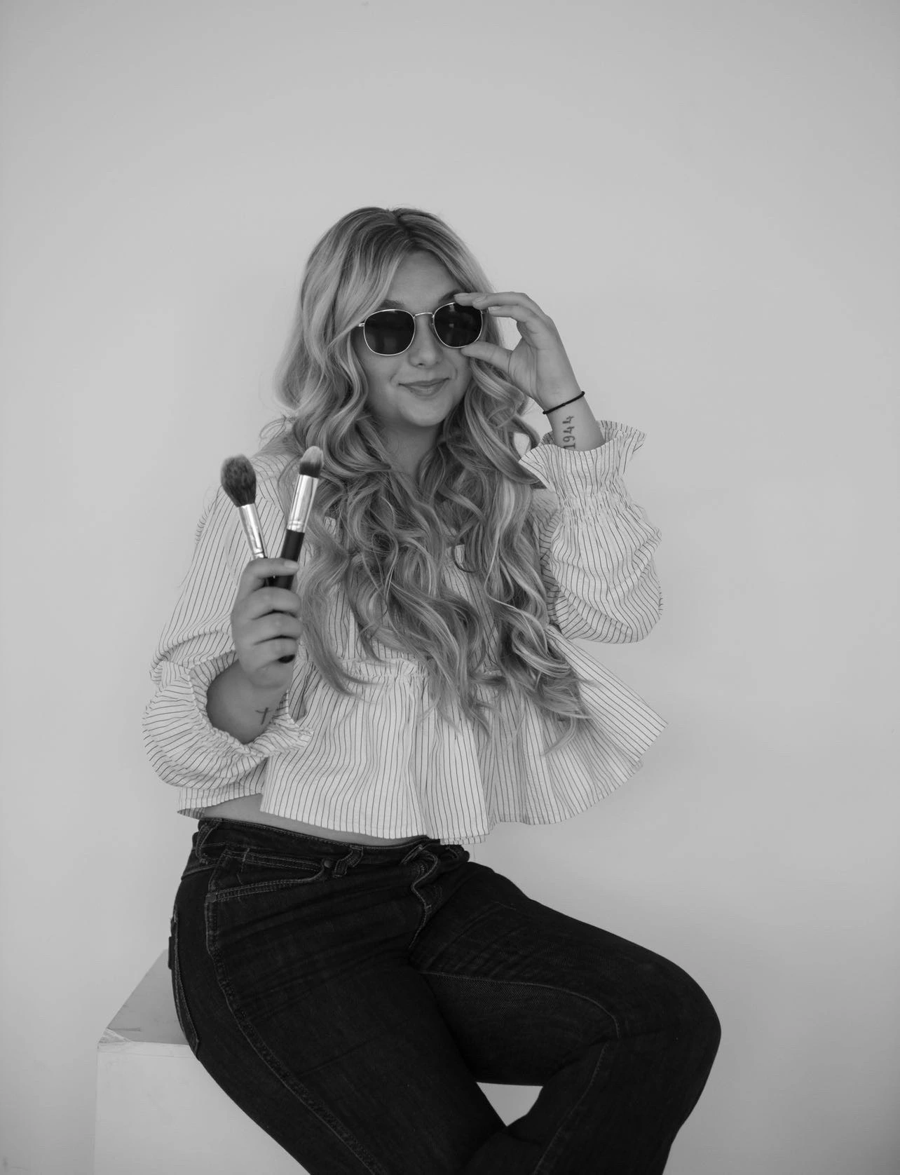 Marisa Cleary holding makeup brushes